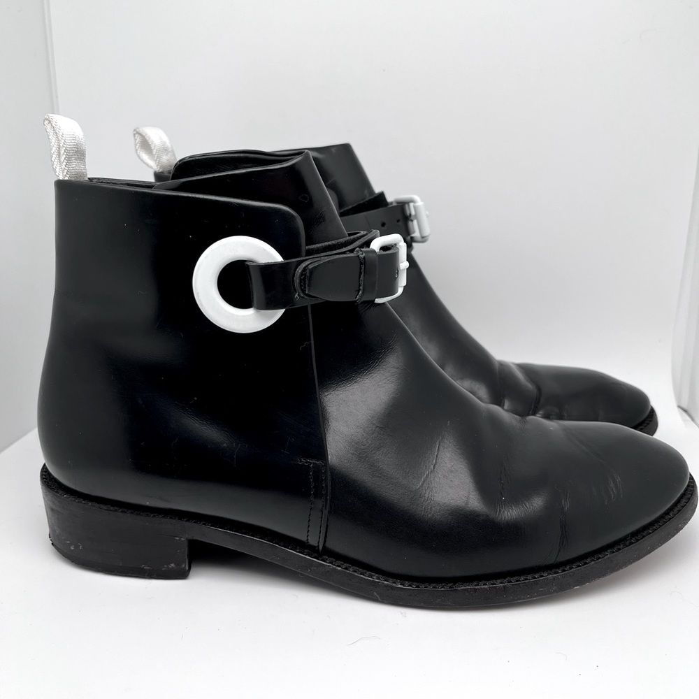 Acne Studios black leather ankle boots with white grommet and buckle, size 39